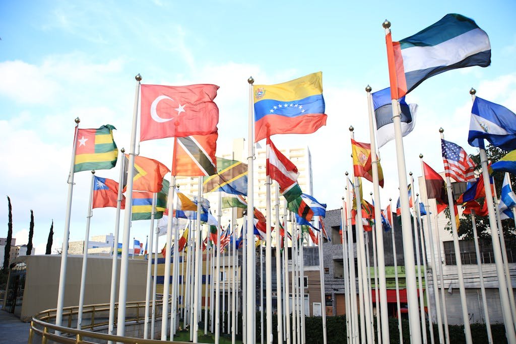 A vibrant collection of international flags in a cityscape setting, symbolizing global unity.